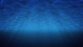 Rays of sunlight shining from above penetrate deep clear blue water. Sun light beams underwater. Small bubbles move up Royalty Free Stock Photo