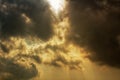 Rays of sunlight shining through dark storm clouds Royalty Free Stock Photo