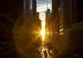 Rays of sunlight shining between the skyline buildings along 42nd Street in Midtown Manhattan, New York City Royalty Free Stock Photo