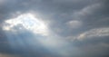 Rays of sunlight through stormy clouds