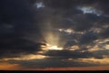 The rays of sunset break through the clouds. Royalty Free Stock Photo