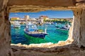 Razanac turquoise waterfront through stone window