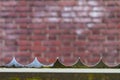 Razor fence with brick background