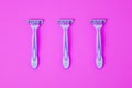 Razor for hair depilation. Body care. Three disposable razors on a pink background Royalty Free Stock Photo