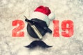 Razor on a plate for foam with a Santa Claus hat on a gray background. Inscription 2019. Greeting card Happy New Year Royalty Free Stock Photo