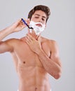 Razor, shave and man on gray background with foam for wellness, hair removal and beauty in studio. Skincare, dermatology Royalty Free Stock Photo