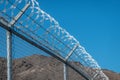 Razor wire or barbed tape top a chain link fence Royalty Free Stock Photo