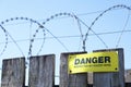 Razor wire fence protection security danger sign on fence construction building site Royalty Free Stock Photo