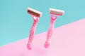 Razors on blue and pink background close-up. Royalty Free Stock Photo