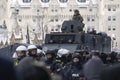 RCMP officer sits atop an armored vehicle as police drive Freedom Convoy protestors away from Parliament Hill in Ottawa