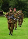 Re-enactment World War 2 group of four men in British WW2 uniforms with small arms. Royalty Free Stock Photo