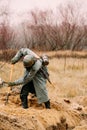 Re-enactor Dressed As German Wehrmacht Infantry Soldier In World War Ii With Shovel Digs Trench. Arrangement Of A Royalty Free Stock Photo