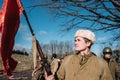 Re-enactor Dressed As Russian Soviet Infantry Soldier Of World War II Holding Red Flag