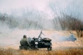 Re-enactor Dressed As World War Ii German Wehrmacht Infantry Soldier Sit Near Old Tricar, Armed Machinegun. Smokescreen