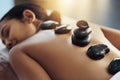 Re-energize and heal aching muscles. a young woman getting a hot stone massage at a spa. Royalty Free Stock Photo