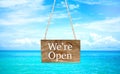 We`re open on hanging wood banner