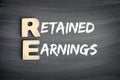 RE - Retained Earnings acronym, business concept on blackboard Royalty Free Stock Photo
