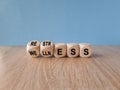 Re str ess for we lln ess symbol. Concept words Restress and Wellness on wooden cubes