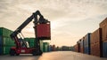 Reach stacker lifting container in sunset-lit yard with stacked cargo and paved pathway Royalty Free Stock Photo