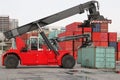 Reach stacker vehicle moving a container into a container terminal area