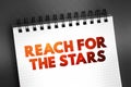 Reach For The Stars text quote on notepad, concept background Royalty Free Stock Photo