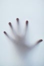 Reaching out into the void. Defocussed shot of a single hand reaching out against a plain background. Royalty Free Stock Photo
