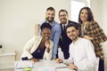 Happy diverse business team looking at camera and smiling after work meeting in office Royalty Free Stock Photo