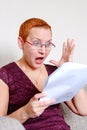 Reaction to errors in the tax report. The emotion of annoyed surprise. She threw her hand up in surprise Royalty Free Stock Photo