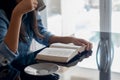 Woman drinking coffee while reading book. Royalty Free Stock Photo