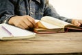 Read a book on a wooden table - Focus hand Royalty Free Stock Photo