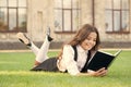 Read every day. Cute small child read library book on green grass. Adorable little girl learning to read at leisure Royalty Free Stock Photo