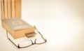 Read glasses selective focus on blur Bookmark in old book on white background copy space Royalty Free Stock Photo