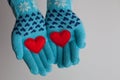 Red hearts in hands in warm gloves for Valentines Day