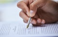 Read through our terms and sign when youre ready. Closeup shot of an unrecognisable man going through paperwork. Royalty Free Stock Photo