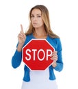 Read the sign. Studio portrait of a stern-looking woman holding a stop sign. Royalty Free Stock Photo