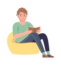 Reader. Man reading literature sitting on yellow comfort armchair, studying in university or library, read interesting Royalty Free Stock Photo