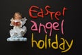 Reading Angel Figurine, Easter Holiday Composition in White, Black, Pink, Red and Yellow Royalty Free Stock Photo