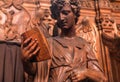 Reading angel holding an old book, wooden statue in 17th century catholic church Saint Charles Borromeo in Antwerp Royalty Free Stock Photo