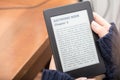 Reading a book with an e-book reader Royalty Free Stock Photo