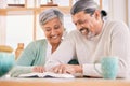 Reading, book and senior couple smile at home with bible study and religion together in marriage. House, happy and Royalty Free Stock Photo