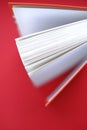 Reading books.Learning and knowledge concept. Book with a red cover on a red background.Book pages. top view, copy space Royalty Free Stock Photo