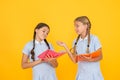 Reading books. Reading and retelling. Small children holding books yellow background. Sincere interest. Little girls Royalty Free Stock Photo