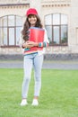 Reading days. Stylish pupil or young learner. Cute pupil holding books outdoor. Small pupil going to library. Little