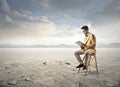 Reading in a desert Royalty Free Stock Photo