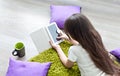 Reading e-books. little girl reading e-book while lying on the floor. Royalty Free Stock Photo