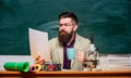 Reading essay. Handsome teacher relaxing. Teacher bearded man drinking tea chalkboard background. Self care and life Royalty Free Stock Photo