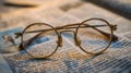 reading glasses and a ballpoint pen lie on a newspaper Royalty Free Stock Photo