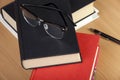 Reading glasses laying on top of a pile of books Royalty Free Stock Photo