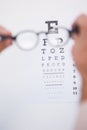 Reading glasses looking at eye test Royalty Free Stock Photo