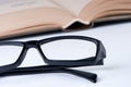 Reading glasses with open book.